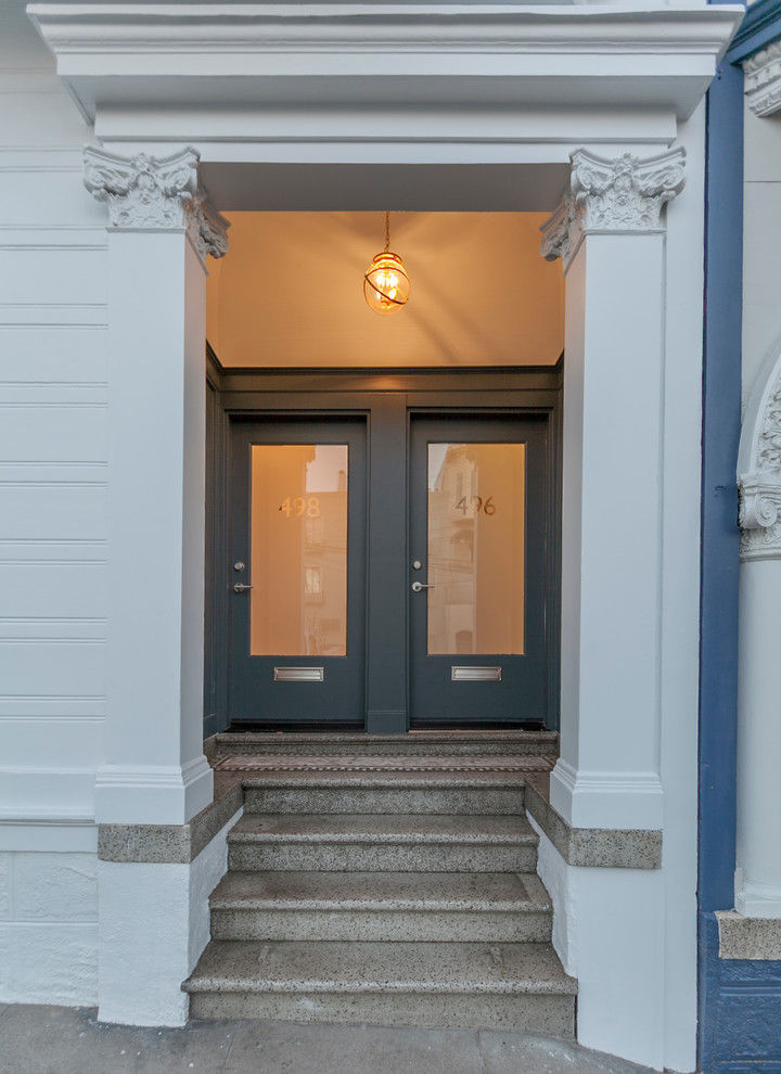 Photo of a small traditional foyer in San Francisco with white walls, terrazzo floors, a double front door and a gray front door.