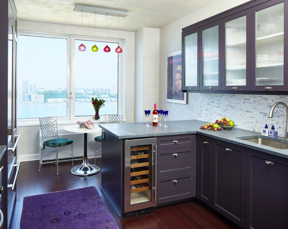 Inspiration for an eclectic l-shaped eat-in kitchen in New York with an undermount sink, purple cabinets, multi-coloured splashback, dark hardwood floors, a peninsula and glass-front cabinets.
