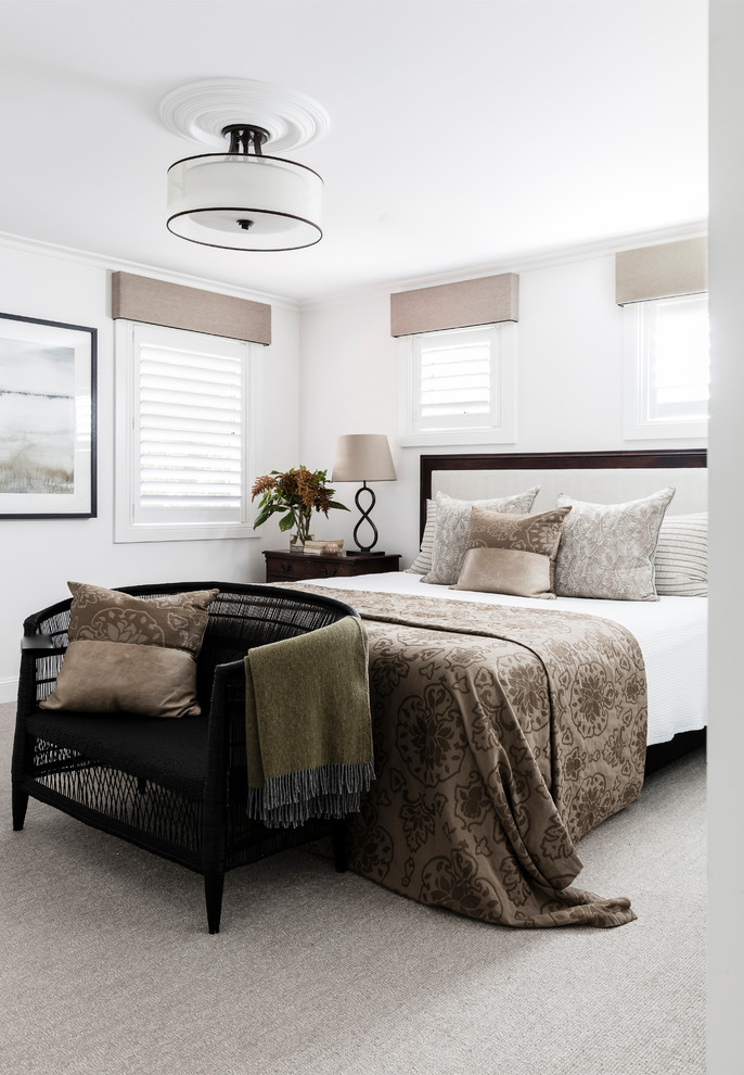 This is an example of a transitional bedroom in Sydney with white walls, carpet and grey floor.