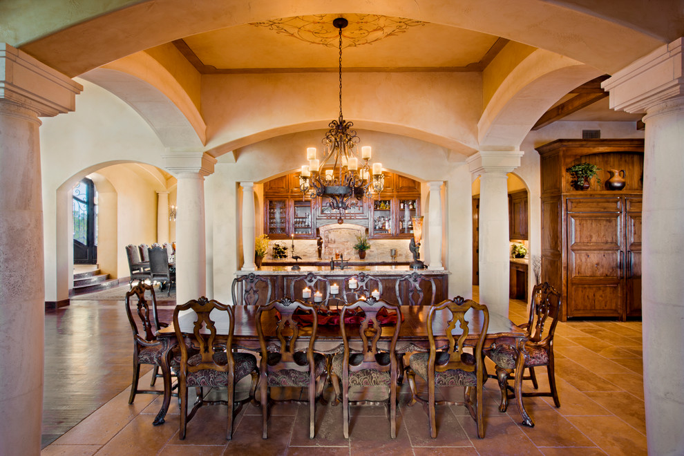 Large mediterranean open plan dining in Austin with beige walls, laminate floors, no fireplace and brown floor.