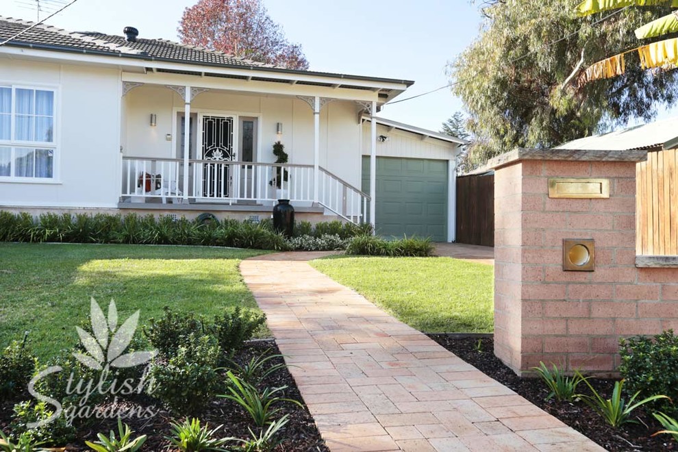Design ideas for a small modern front yard full sun driveway for summer in Sydney with a garden path and brick pavers.