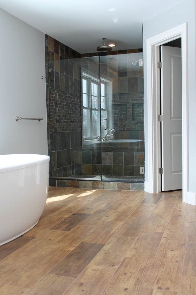 Inspiration for a contemporary master bathroom in New York with a freestanding tub, wood-look tile, ceramic floors, multi-coloured tile and blue walls.