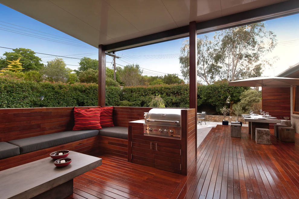 Inspiration for a small contemporary backyard deck in Canberra - Queanbeyan with a roof extension.