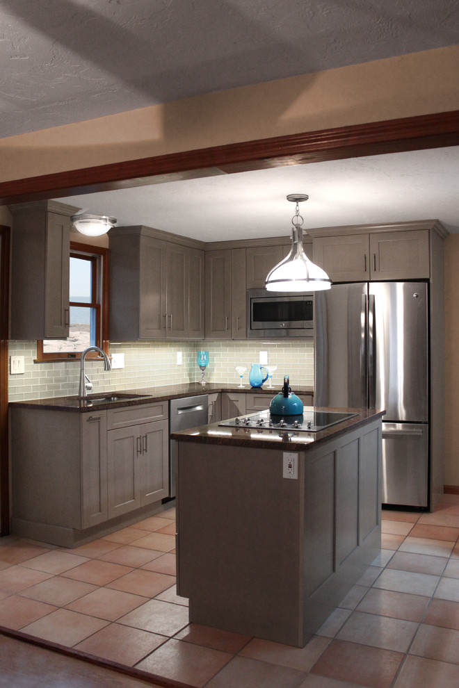 Eat-in kitchen - mid-sized transitional l-shaped ceramic tile eat-in kitchen idea in Boston with an undermount sink, shaker cabinets, gray cabinets, granite countertops, gray backsplash, glass tile backsplash, stainless steel appliances and an island
