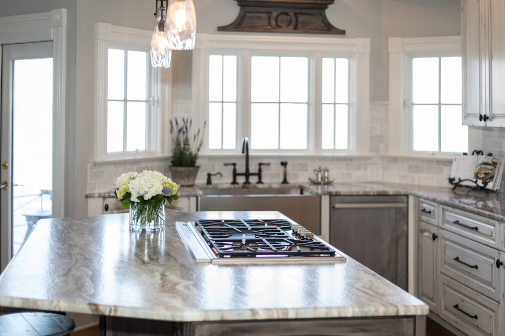Inspiration for a mid-sized transitional u-shaped eat-in kitchen in Charlotte with a farmhouse sink, raised-panel cabinets, distressed cabinets, quartzite benchtops, white splashback, marble splashback, stainless steel appliances, medium hardwood floors, with island and brown floor.