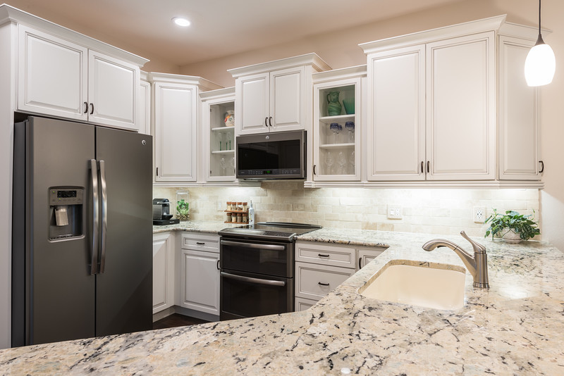 Eat-in kitchen - transitional u-shaped eat-in kitchen idea in Orlando with flat-panel cabinets and no island