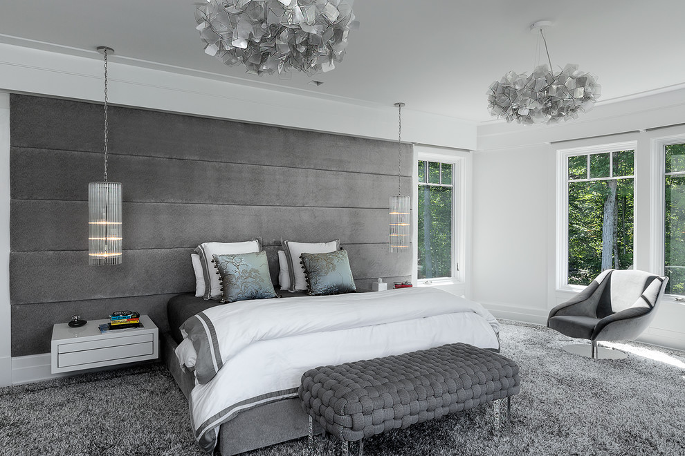 This is an example of a contemporary master bedroom in New York with grey walls, carpet and grey floor.