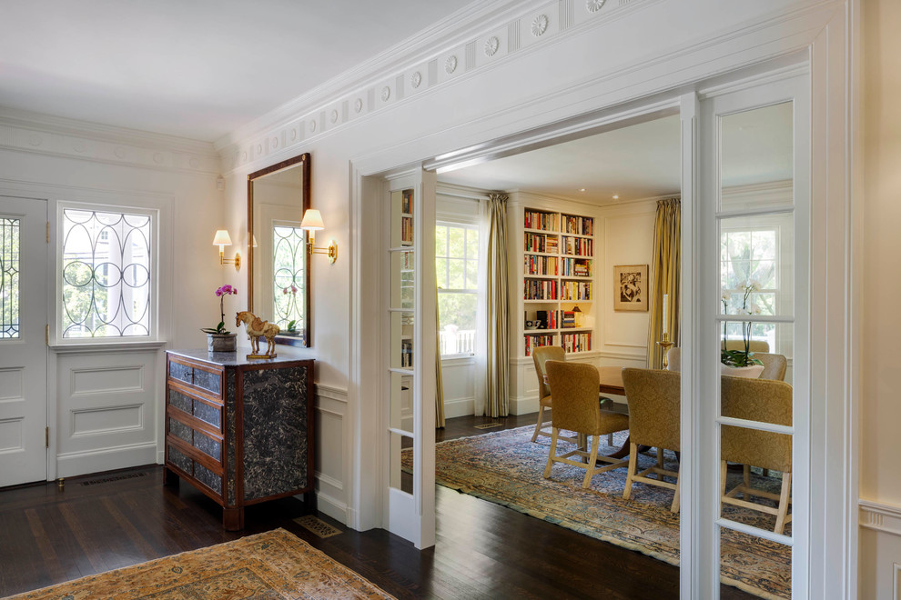 Inspiration for a mid-sized traditional foyer in Boston with white walls, dark hardwood floors, a single front door, a white front door and brown floor.