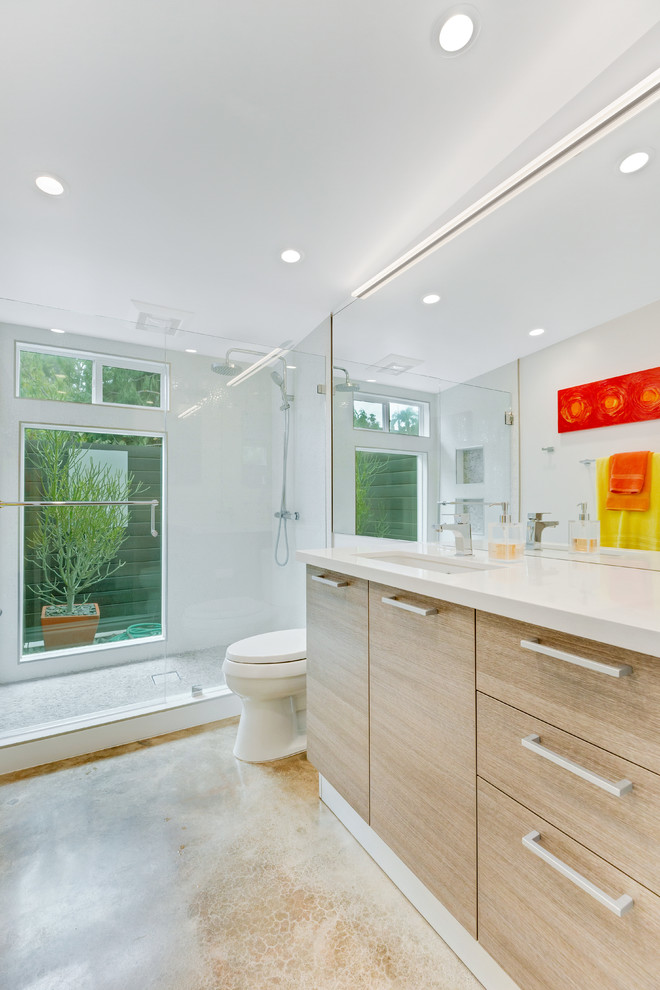Modern bathroom in Orange County with flat-panel cabinets and light wood cabinets.