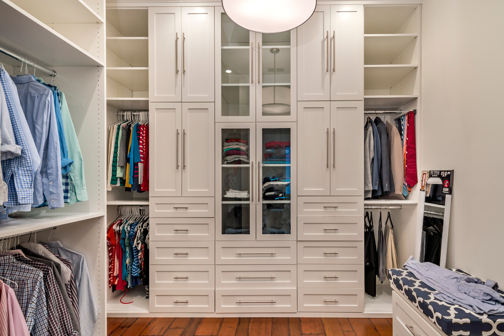 Photo of a transitional walk-in wardrobe in San Francisco with shaker cabinets, white cabinets and dark hardwood floors.