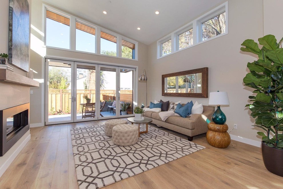 Mid-sized contemporary formal open concept living room in San Francisco with beige walls, light hardwood floors, a ribbon fireplace, a metal fireplace surround, no tv and brown floor.