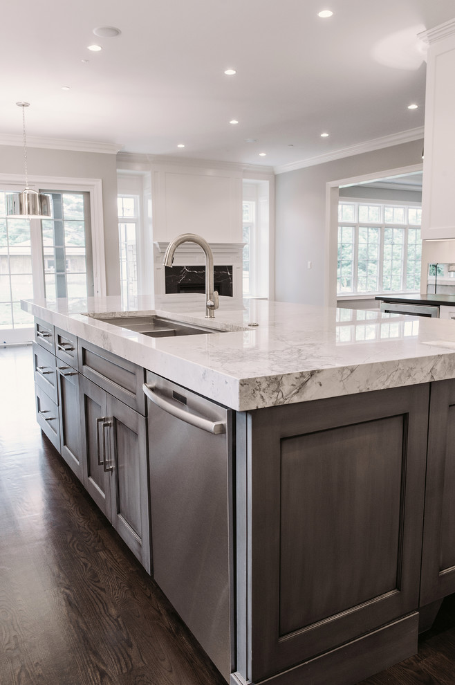 This is an example of a mid-sized transitional u-shaped eat-in kitchen in Chicago with recessed-panel cabinets, grey cabinets and with island.