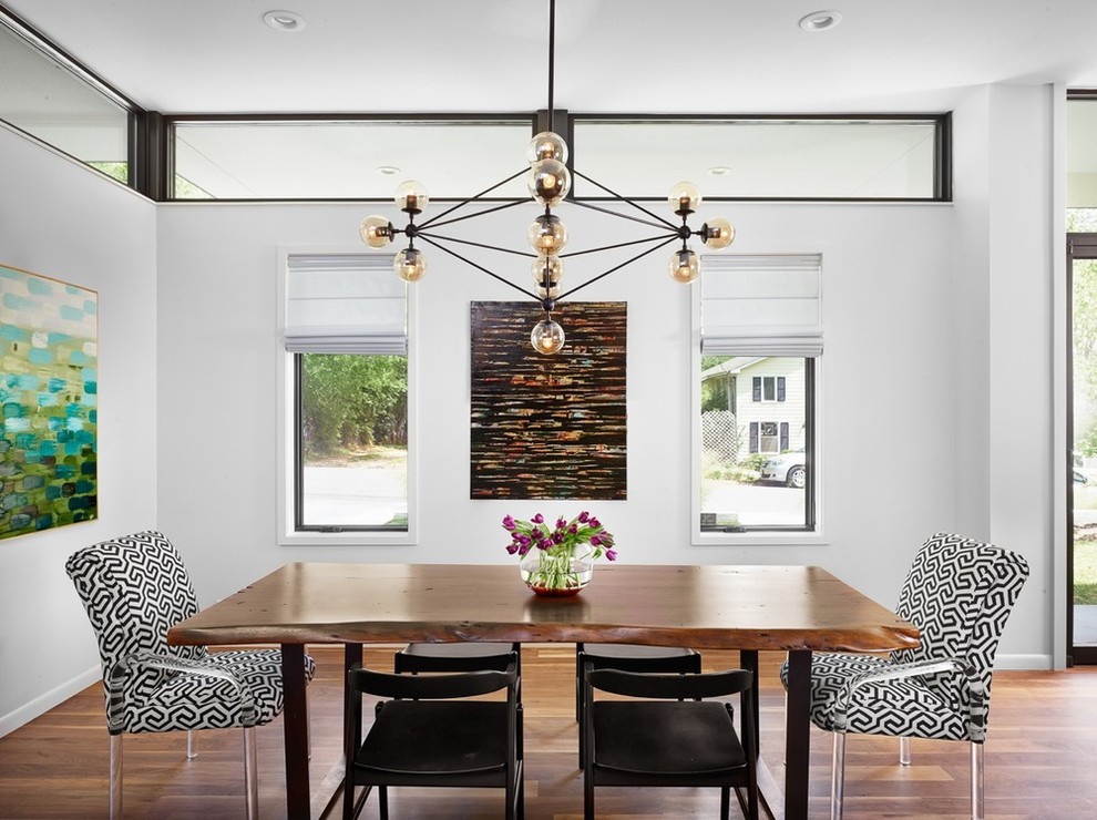 Photo of a contemporary open plan dining in Austin with white walls and dark hardwood floors.