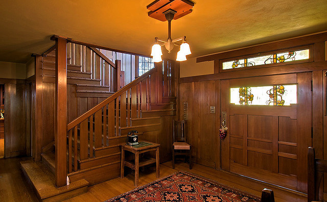 Entryway - large craftsman medium tone wood floor entryway idea in Los Angeles with green walls and a medium wood front door
