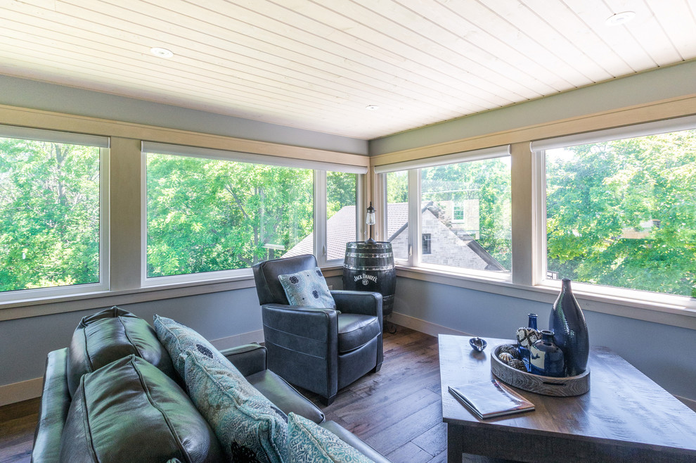 Mid-sized country sunroom in Other with medium hardwood floors, a standard ceiling and brown floor.