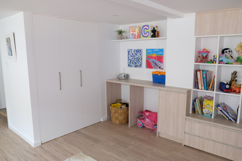 Photo of a large contemporary kids' playroom for kids 4-10 years old in Sydney with white walls and vinyl floors.