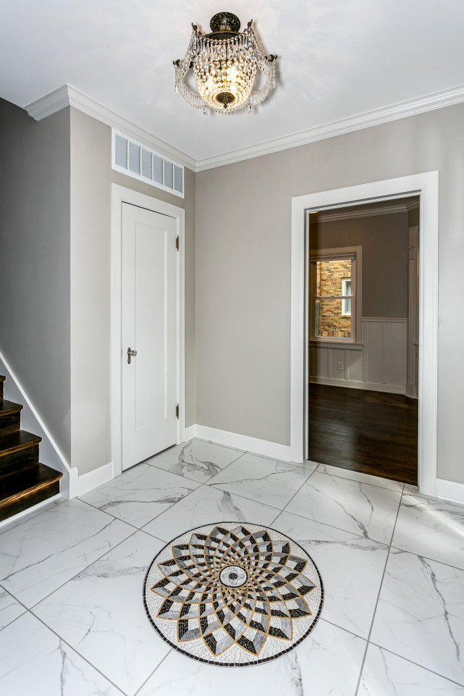 This is an example of a mid-sized traditional foyer in Wichita with grey walls, marble floors and multi-coloured floor.