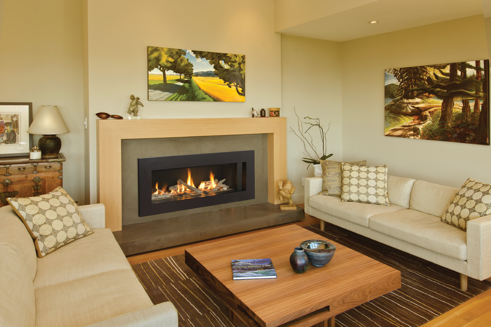 Inspiration for a mid-sized contemporary enclosed living room in Toronto with beige walls and a standard fireplace.