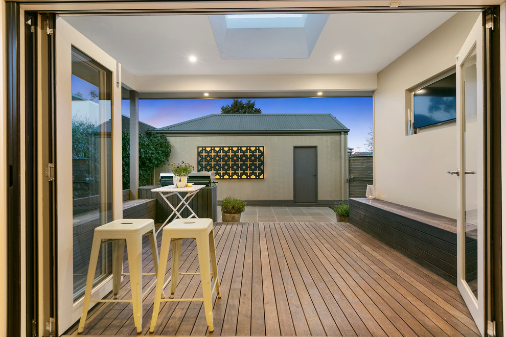 Design ideas for a mid-sized contemporary backyard patio in Melbourne with a water feature and a roof extension.
