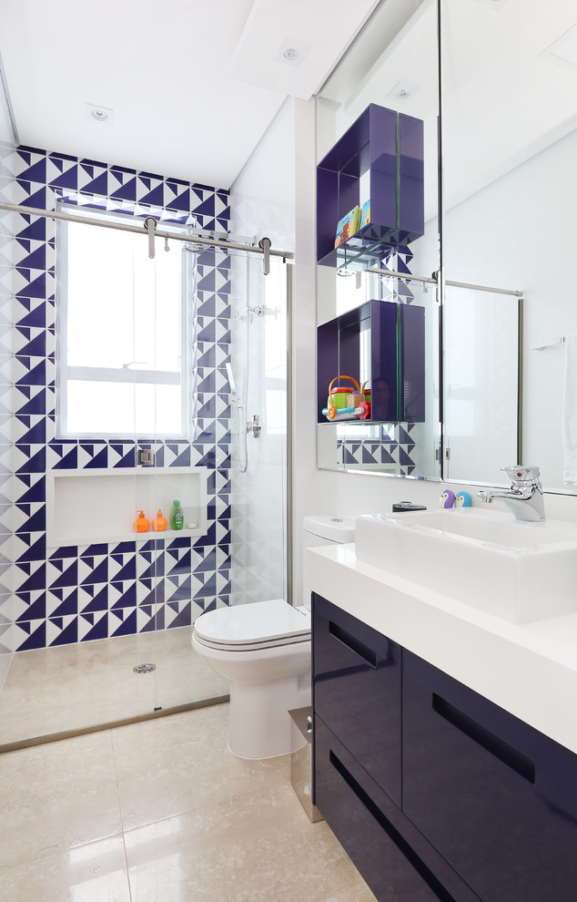 Photo of a contemporary bathroom in Other with flat-panel cabinets, blue cabinets, a curbless shower, blue tile, white tile, white walls, a vessel sink, beige floor, a sliding shower screen and white benchtops.