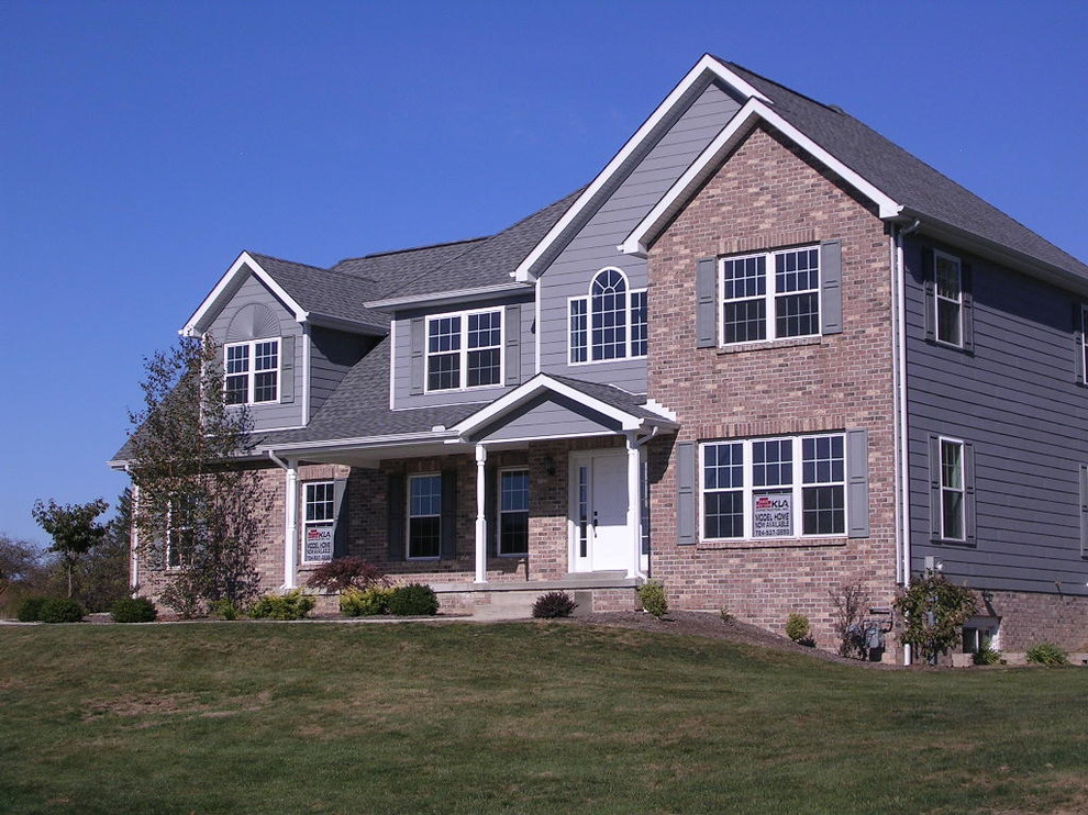 Large transitional multicolored two-story mixed siding gable roof idea with a shingle roof