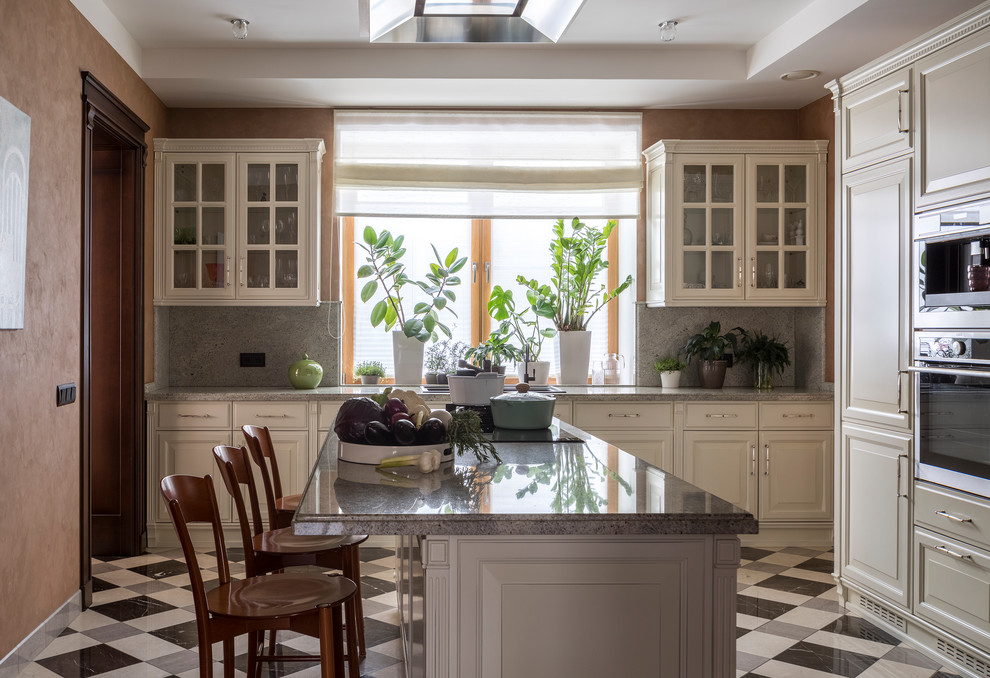 Design ideas for a large transitional l-shaped separate kitchen in Moscow with granite benchtops, grey splashback, marble splashback, porcelain floors, with island, multi-coloured floor, a drop-in sink, raised-panel cabinets, grey benchtop, beige cabinets and panelled appliances.