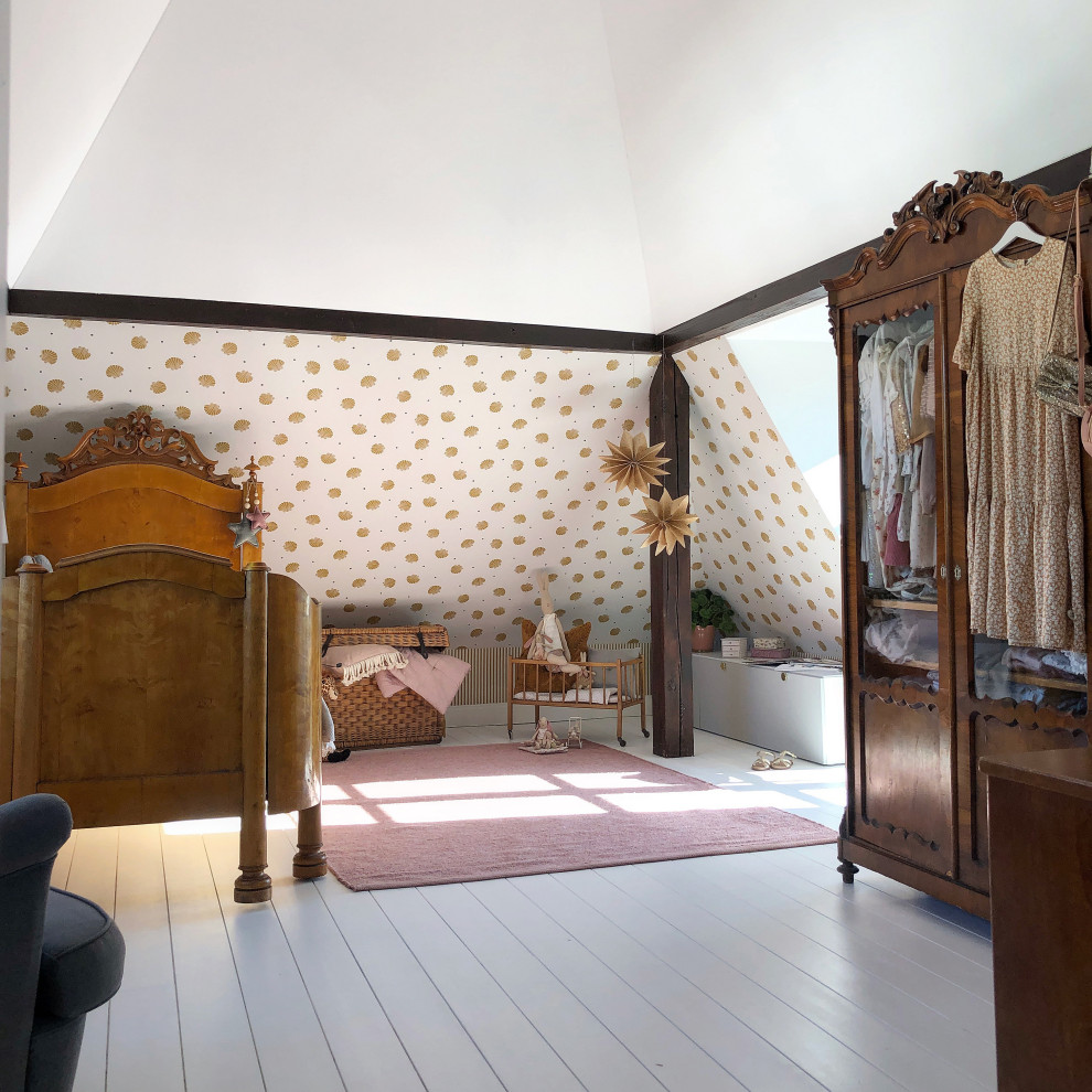 Photo of a large traditional children’s room for girls in Munich with white walls, light hardwood flooring, white floors and wallpapered walls.