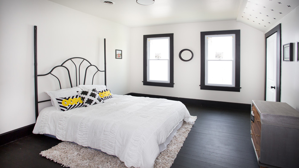 Large transitional guest painted wood floor and black floor bedroom photo with white walls