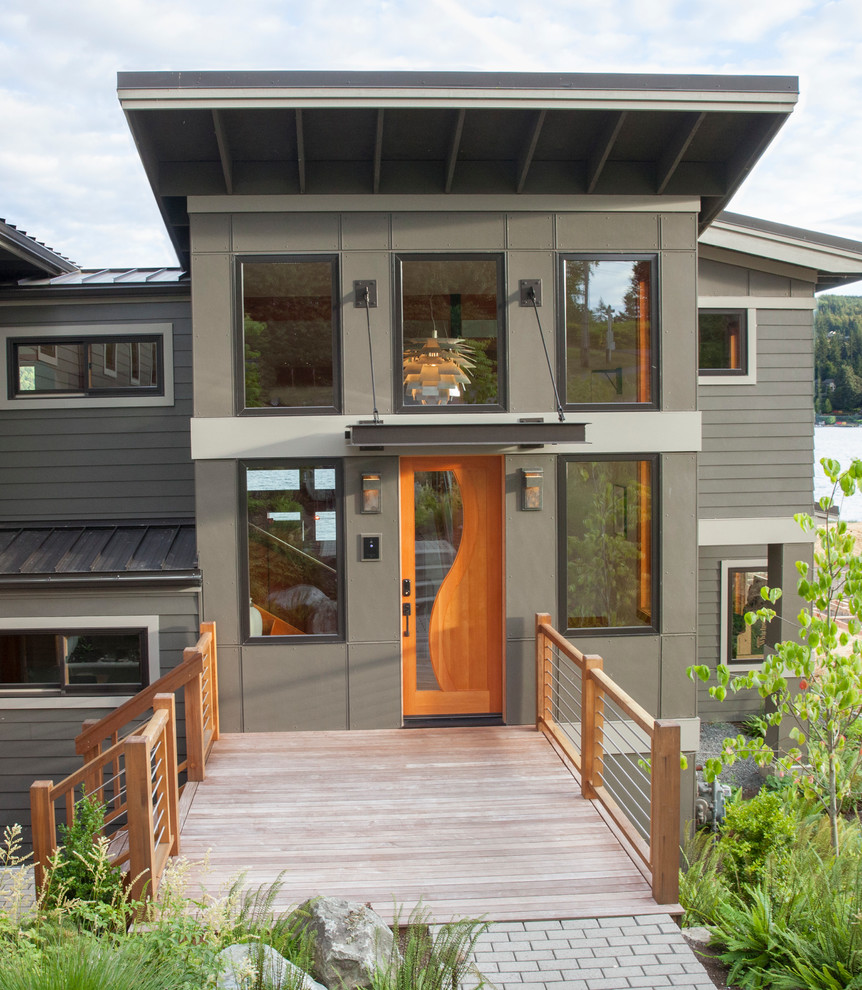 This is an example of a mid-sized contemporary split-level grey exterior in Seattle with concrete fiberboard siding.