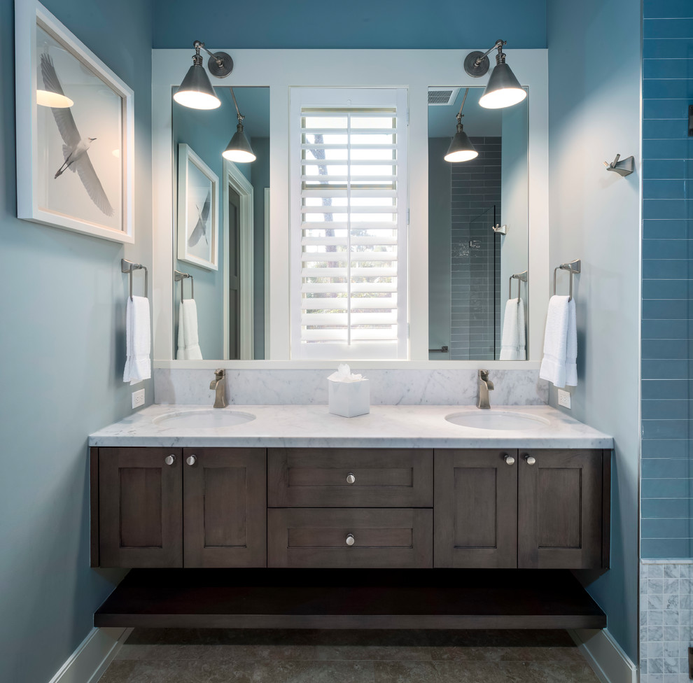 Photo of a small transitional bathroom in Miami with dark wood cabinets, blue tile, subway tile, blue walls, travertine floors, marble benchtops and brown floor.