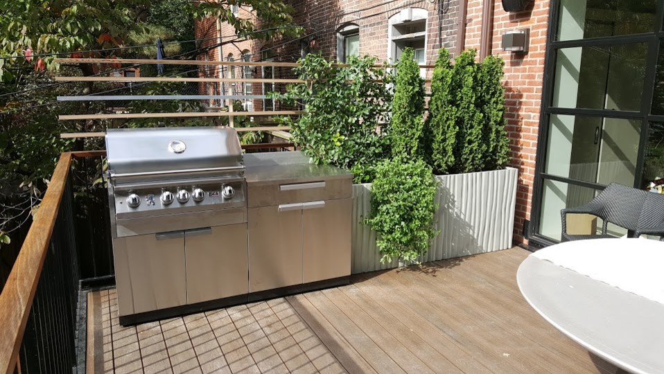 Small contemporary backyard deck in Boston with an outdoor kitchen.