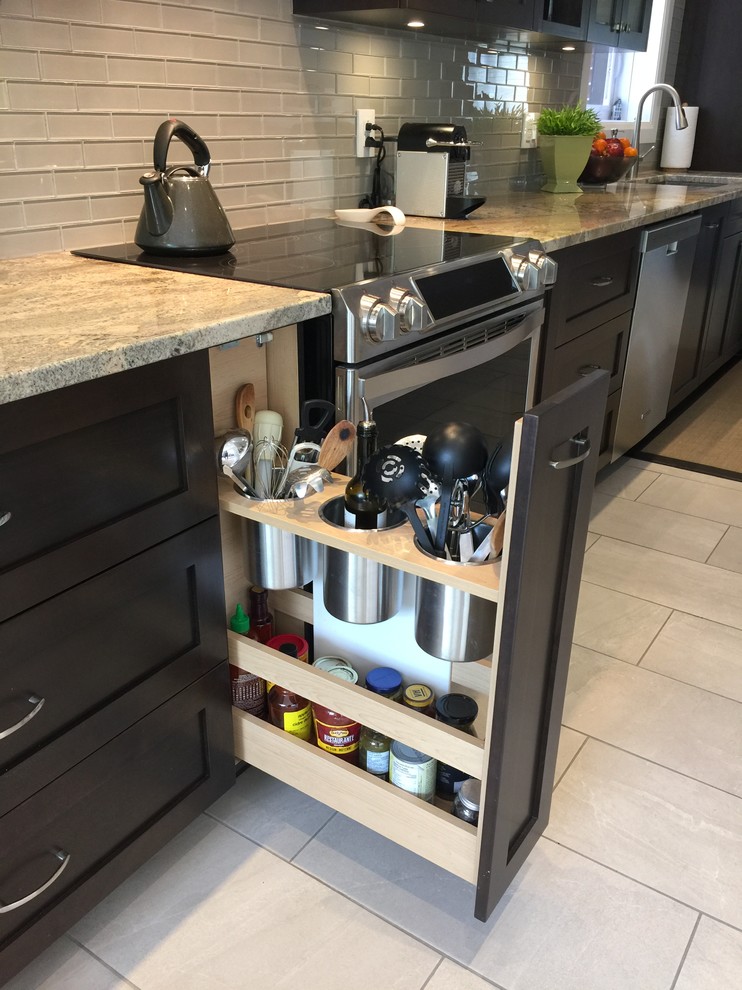Large transitional galley eat-in kitchen in Montreal with an undermount sink, shaker cabinets, dark wood cabinets, granite benchtops, green splashback, glass tile splashback, stainless steel appliances, porcelain floors and a peninsula.