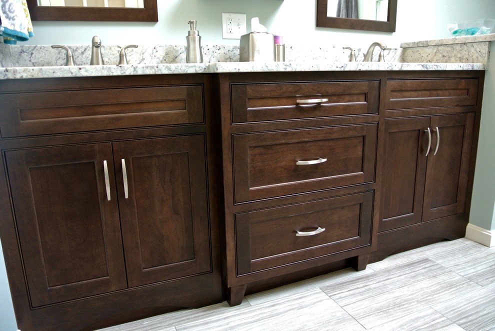 Alcove shower - transitional master porcelain tile and beige floor alcove shower idea in Boston with shaker cabinets, dark wood cabinets, a one-piece toilet, gray walls, an undermount sink, granite countertops and gray countertops