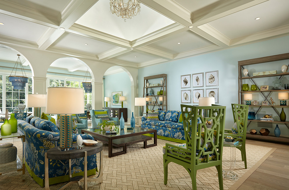 Photo of a traditional living room in Miami with blue walls and light hardwood floors.