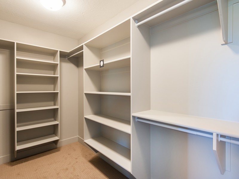 Inspiration for a mid-sized arts and crafts walk-in wardrobe in Salt Lake City with carpet.