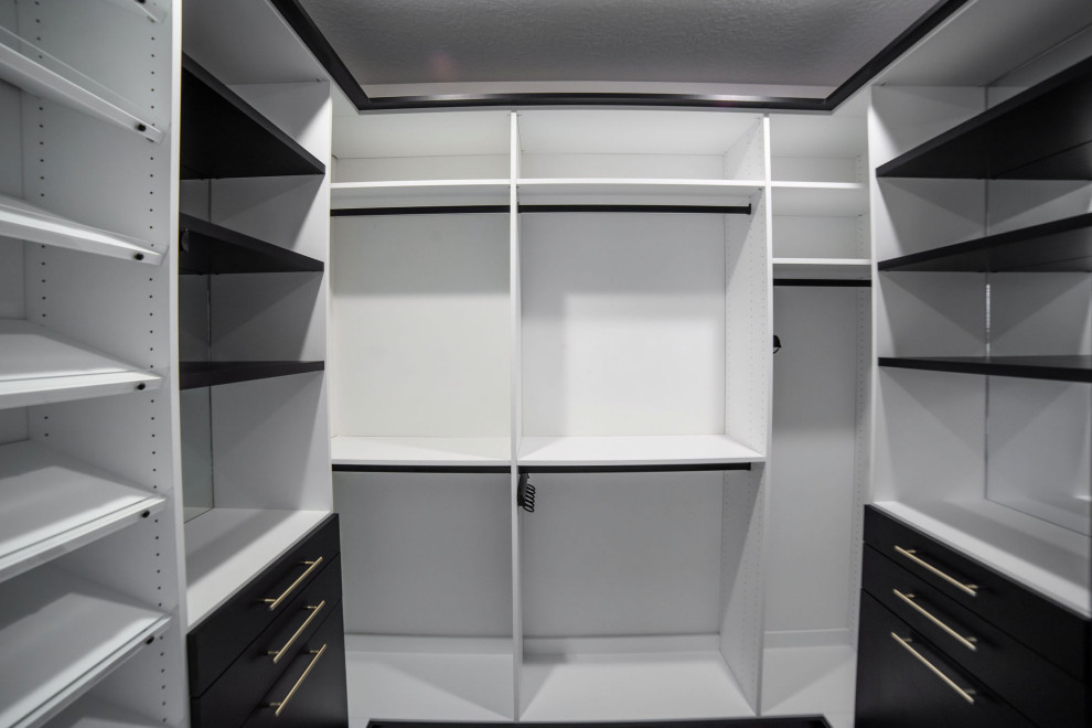 Mid-sized transitional gender-neutral walk-in wardrobe in Other with flat-panel cabinets, white cabinets, carpet and grey floor.