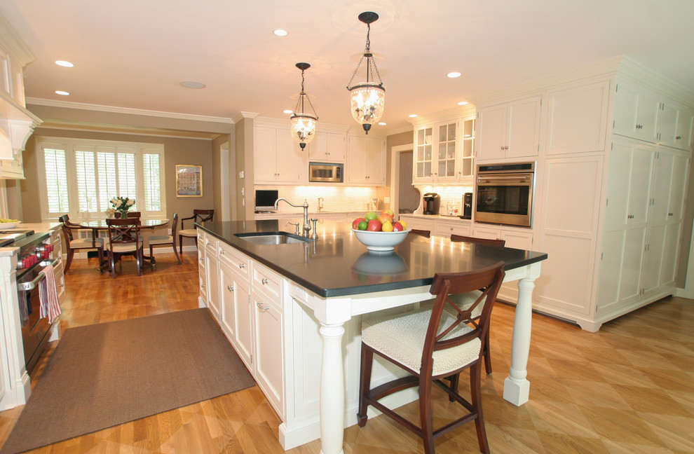 Inspiration for a traditional eat-in kitchen in Boston with an undermount sink, shaker cabinets and white cabinets.