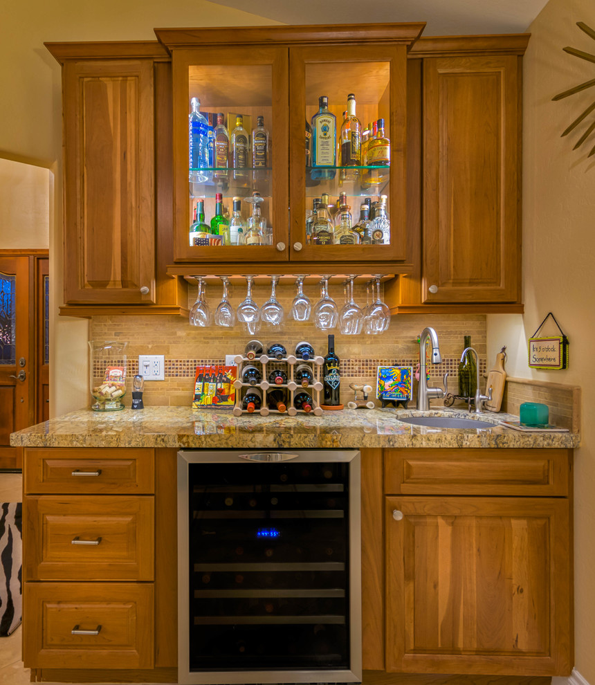 Example of a large transitional u-shaped travertine floor open concept kitchen design in Phoenix with an undermount sink, recessed-panel cabinets, medium tone wood cabinets, granite countertops, beige backsplash, stone tile backsplash, stainless steel appliances and an island