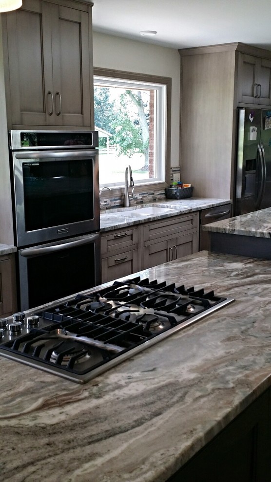 Inspiration for a mid-sized transitional eat-in kitchen remodel with recessed-panel cabinets, granite countertops and two islands