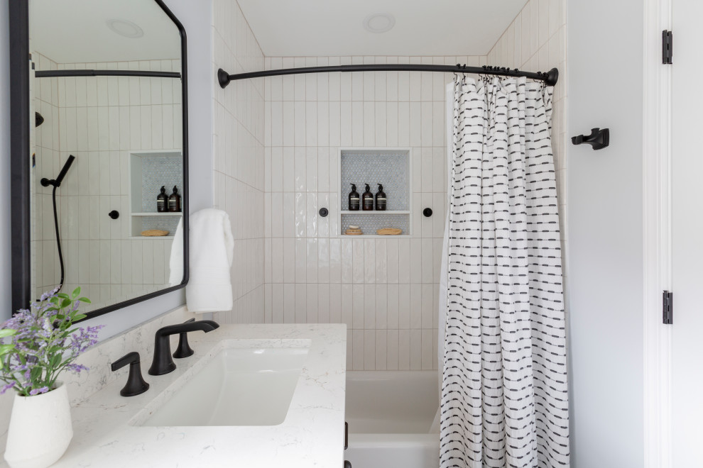 Inspiration for a small transitional 3/4 ceramic tile and single-sink tub/shower combo remodel in New York with medium tone wood cabinets, blue walls, quartz countertops, white countertops and a freestanding vanity