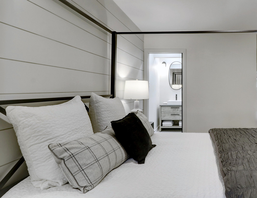 Design ideas for a mid-sized country guest bedroom in Montreal with grey walls, light hardwood floors and planked wall panelling.