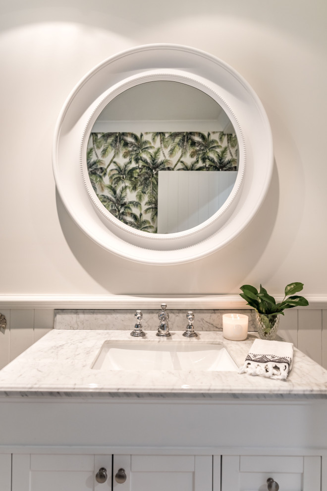 Small tropical bathroom in Sunshine Coast with a freestanding vanity and wallpaper.