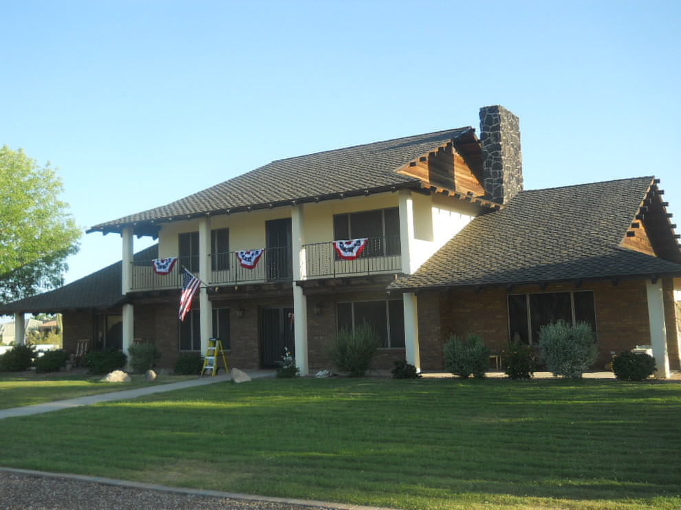 Large transitional multicolored two-story mixed siding house exterior idea in Phoenix with a gambrel roof and a shingle roof