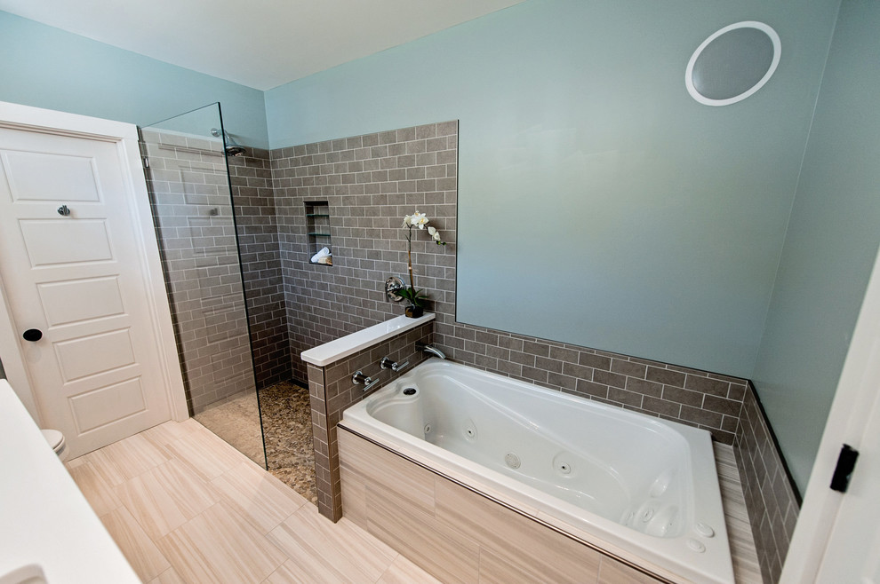 This is an example of a small modern master bathroom in Portland Maine with an undermount sink, flat-panel cabinets, dark wood cabinets, engineered quartz benchtops, a drop-in tub, a curbless shower, a two-piece toilet, multi-coloured tile, subway tile, green walls and porcelain floors.