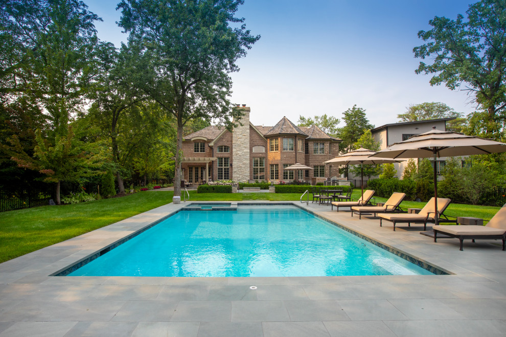 Photo of a medium sized classic back private and rectangular lengths swimming pool in Chicago with natural stone paving.