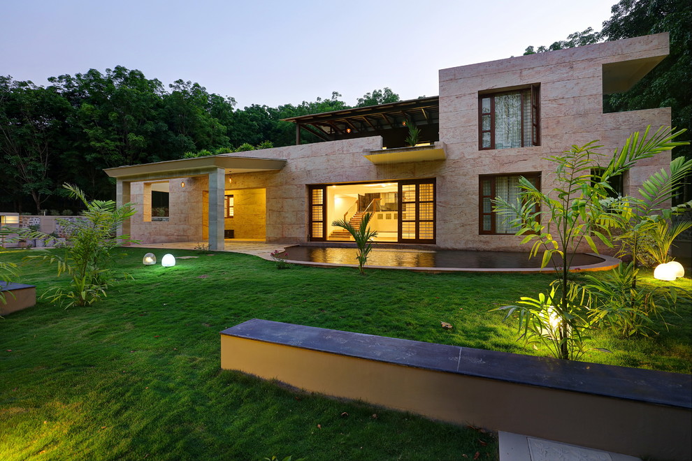 Modern front yard partial sun formal garden in Bengaluru with a water feature and concrete pavers.