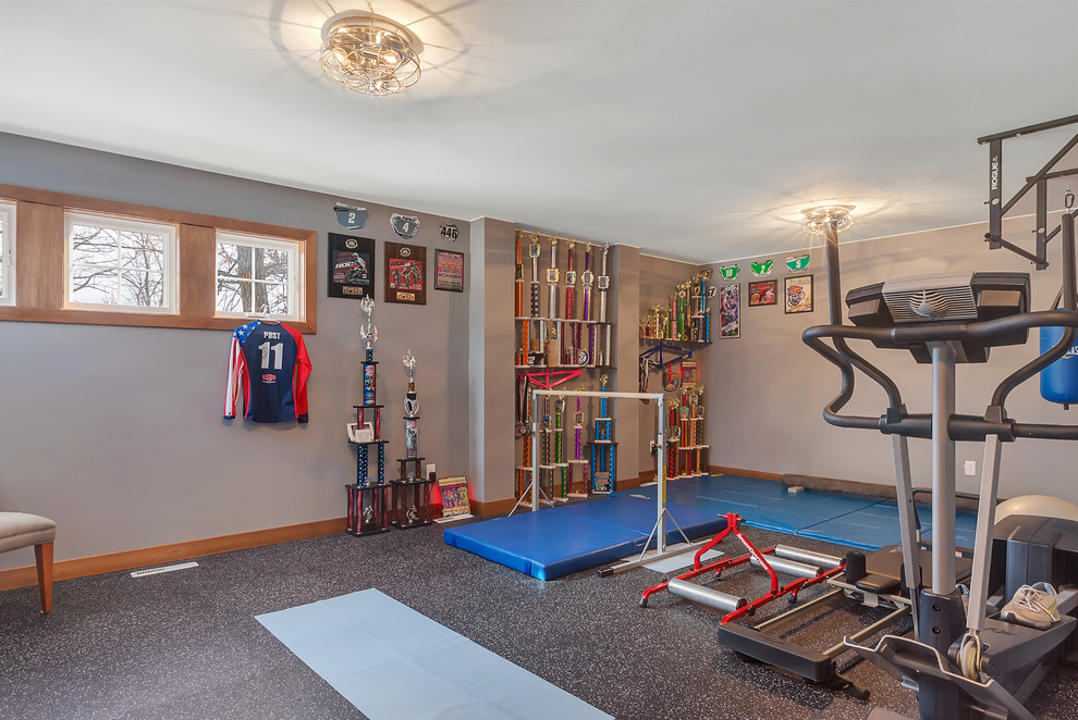 Photo of a mid-sized country home weight room in Minneapolis with grey walls and black floor.