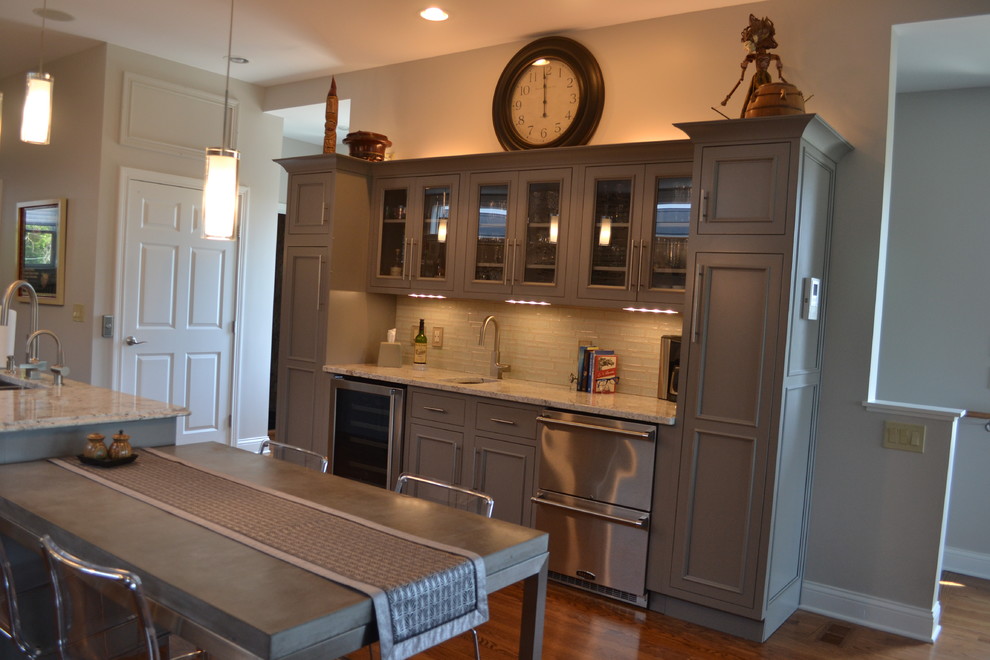 Inspiration for a large transitional l-shaped medium tone wood floor open concept kitchen remodel in Cincinnati with an undermount sink, gray cabinets, granite countertops, multicolored backsplash, mosaic tile backsplash, stainless steel appliances, an island and beaded inset cabinets