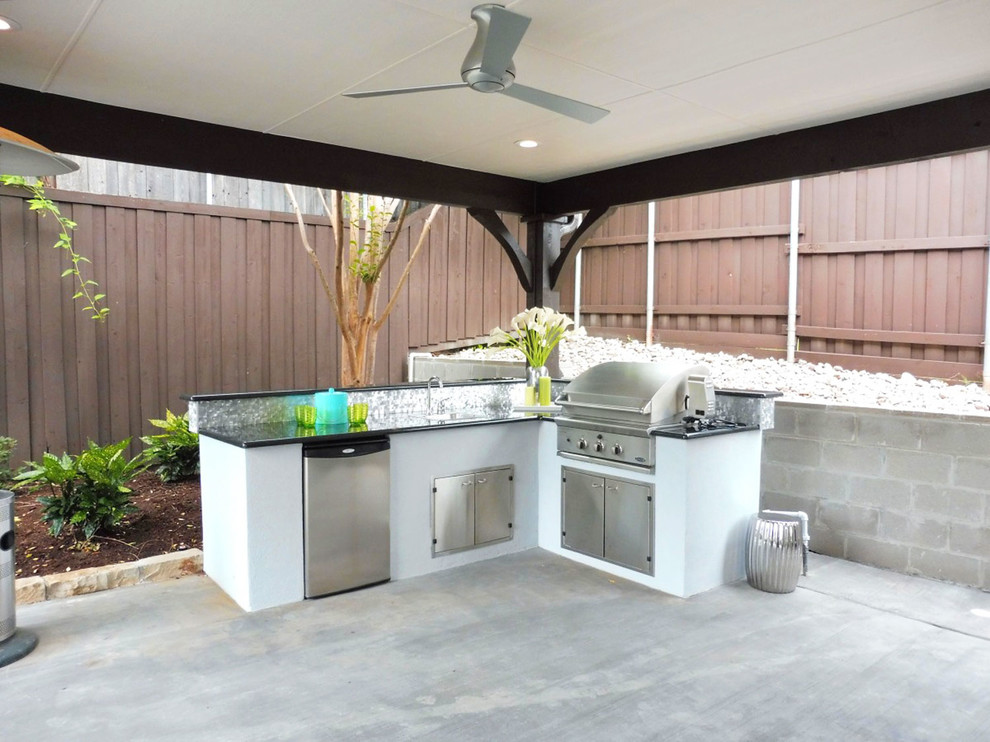 This is an example of a large modern backyard patio in Dallas with concrete slab, an outdoor kitchen and a gazebo/cabana.
