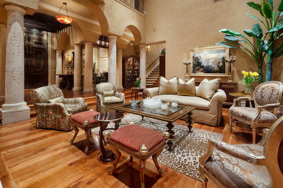 Large mediterranean living room in Austin with beige walls and medium hardwood floors.